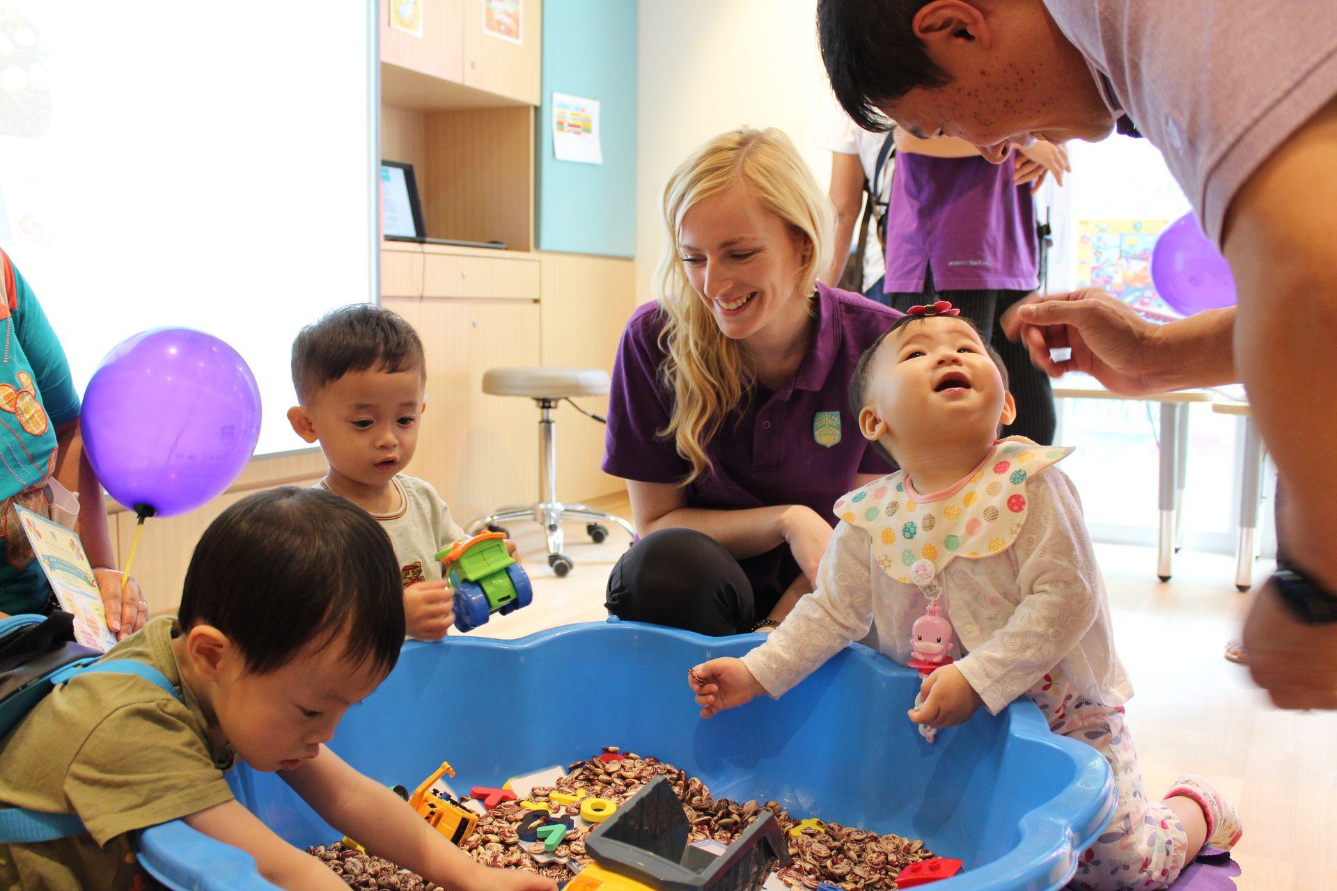 English teacher leading sensory play at mighty oaks open day