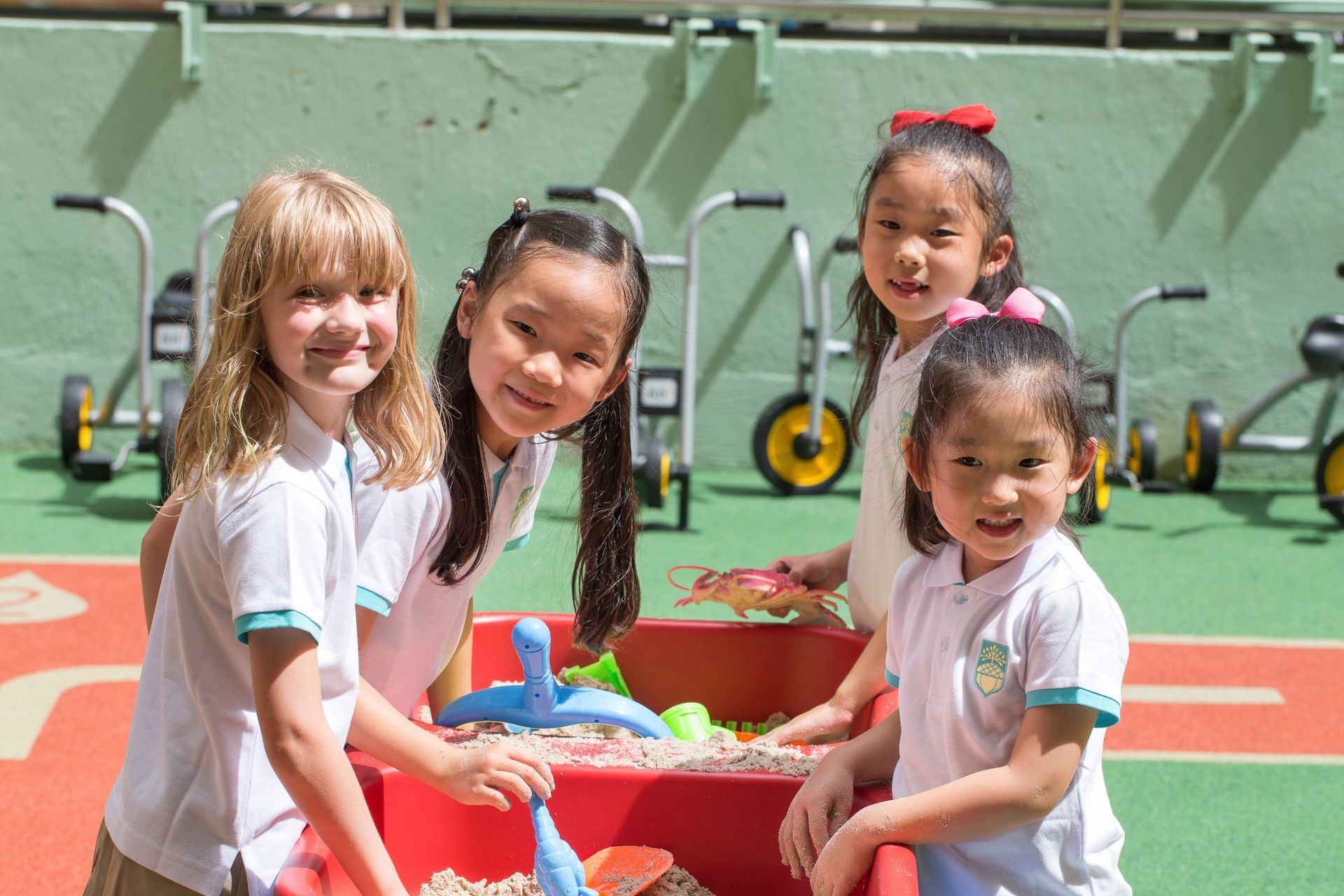 Happy girls playing at our outdoor playgroup sandpit