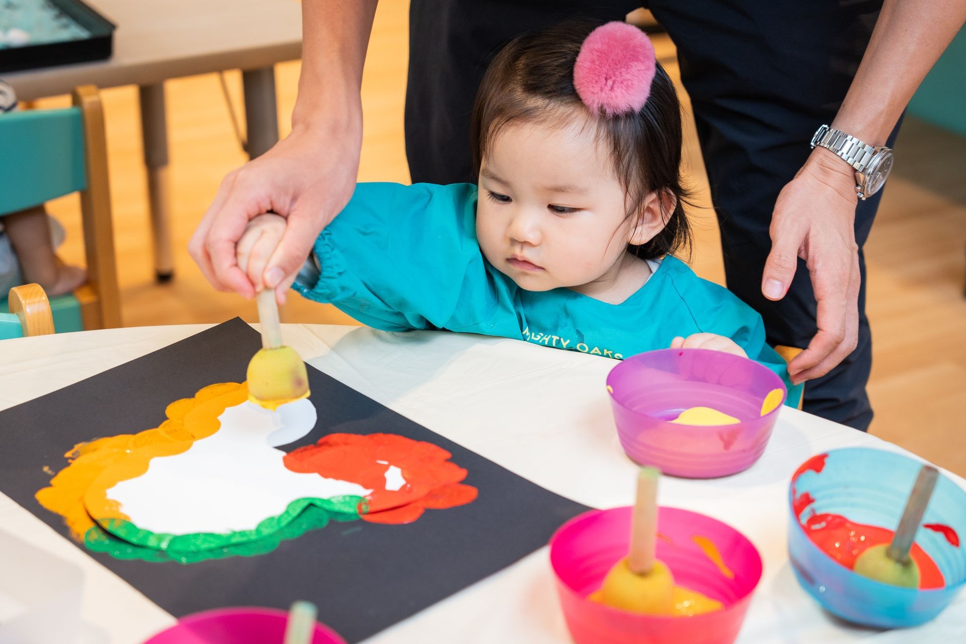 Girl painting during Acorn Playgroup activity