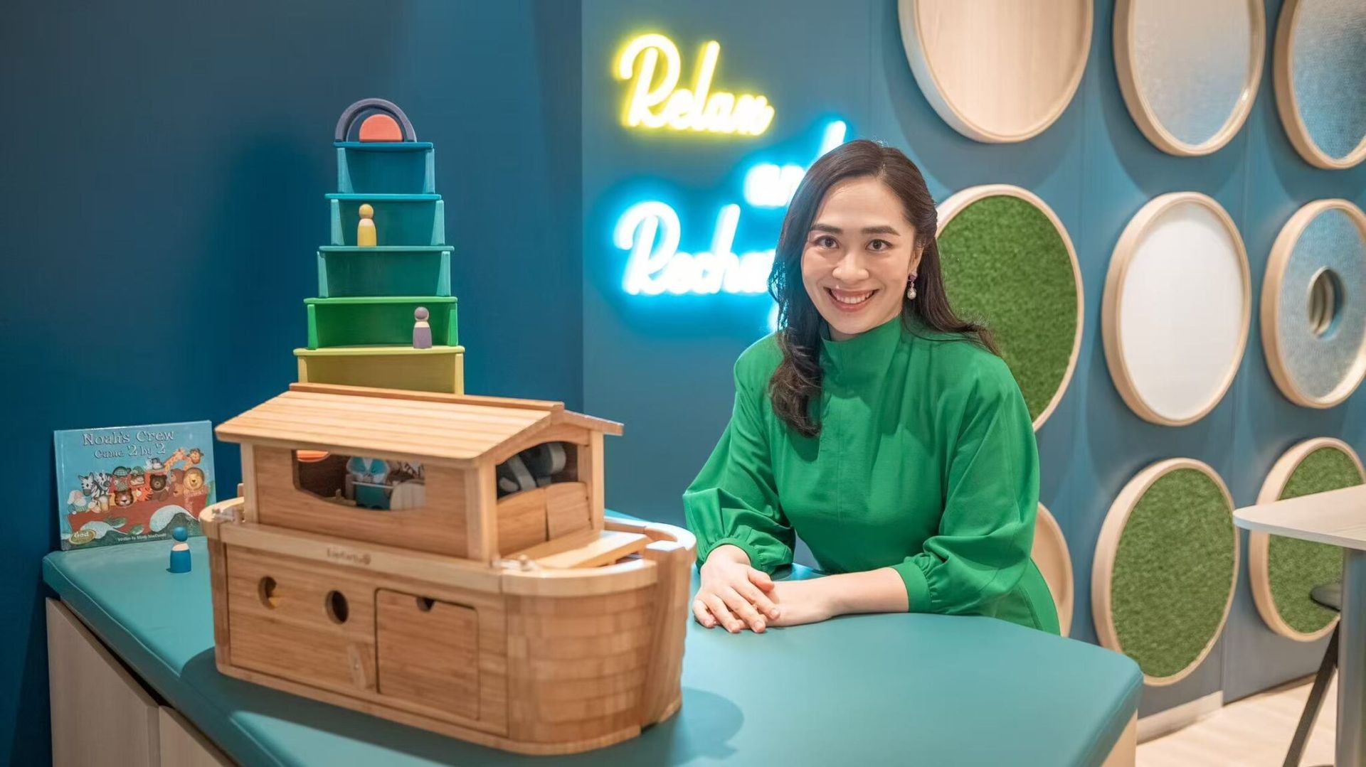 Founder Kimberly surrounded by toys — showcasing her child-friendly approach and passion for early education