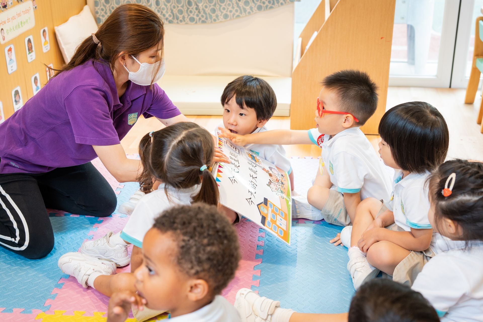 Chinese teacher reading to children at story time