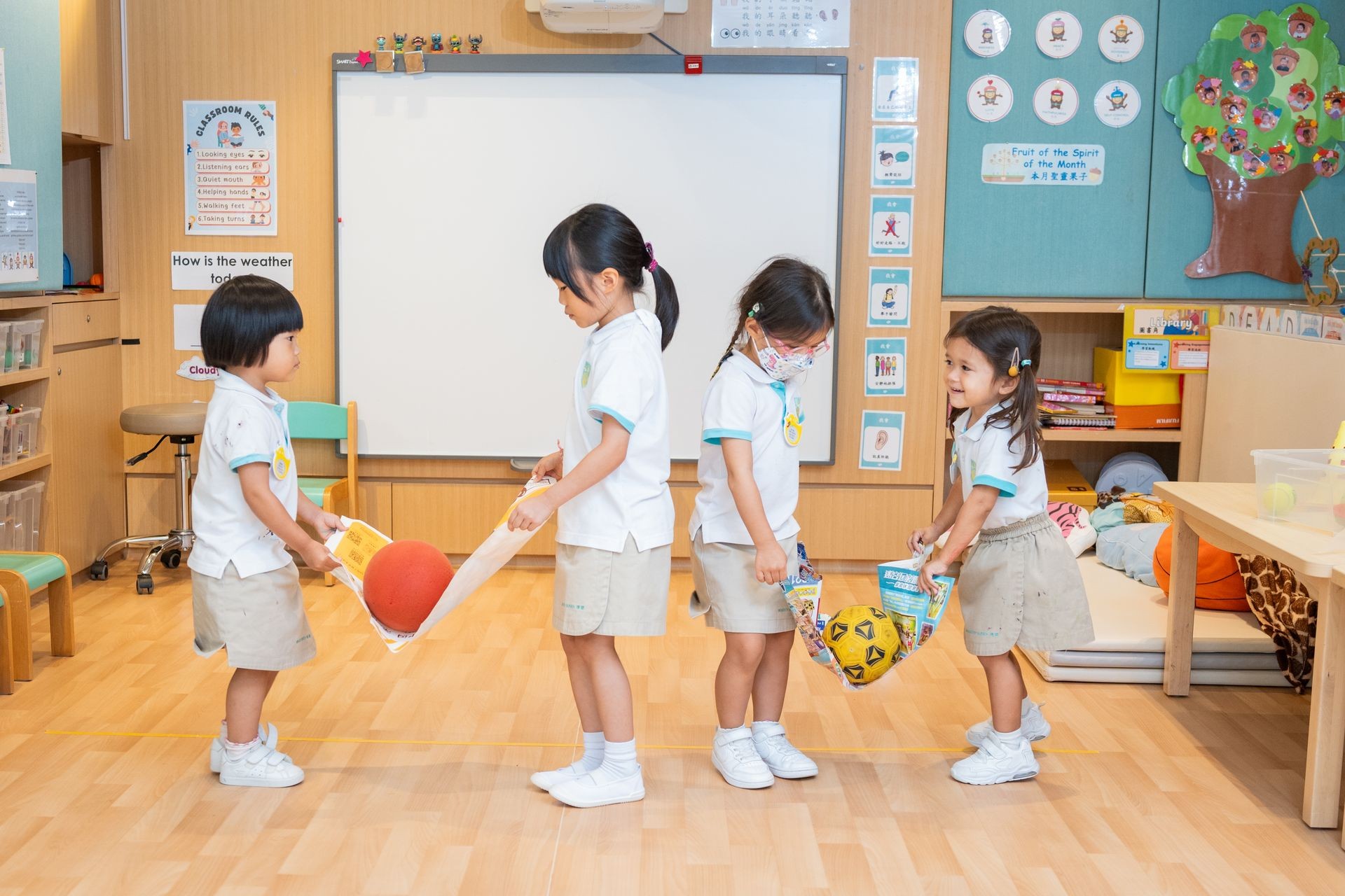 Four girls collaborating in problem-solving activity in Mighty Oaks uniforms